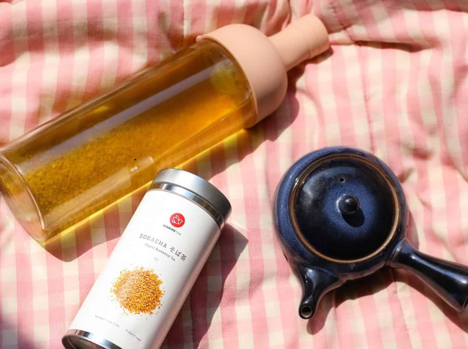 brewed tea in a bottle with tea tin and kyusu teapot