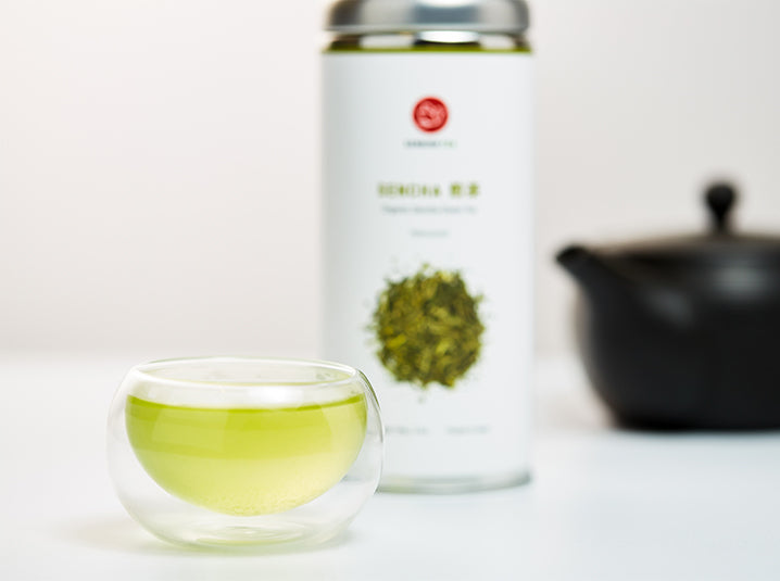 brewed sencha green tea in a cup with sencha tea tin