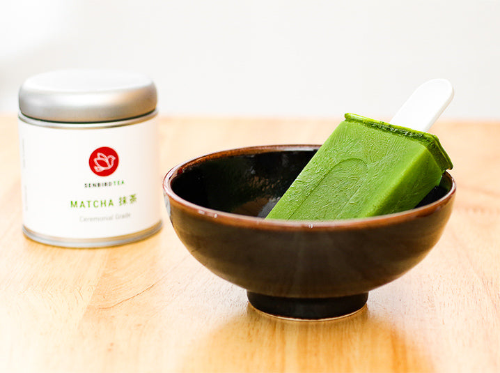 Matcha Green Tea Popsicles in a bowl with matcha tea tin