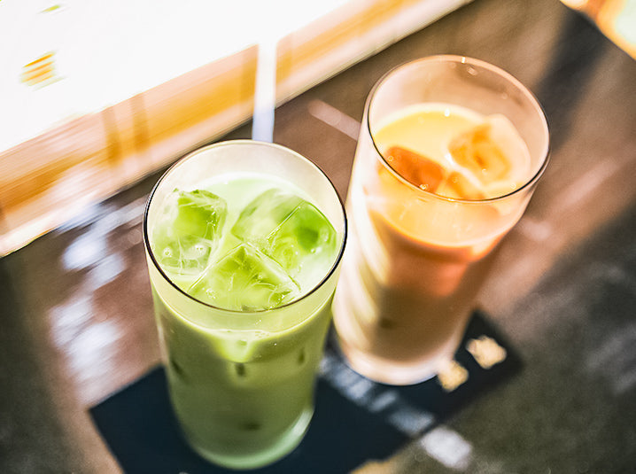 Two glasses filled with Iced Match and Iced Coffee