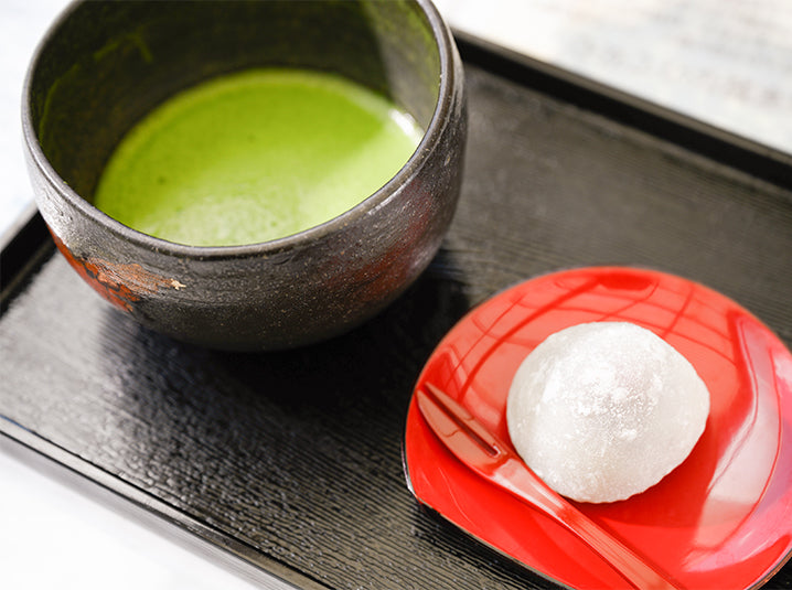 Japanese matcha and snacks on a square wooden board