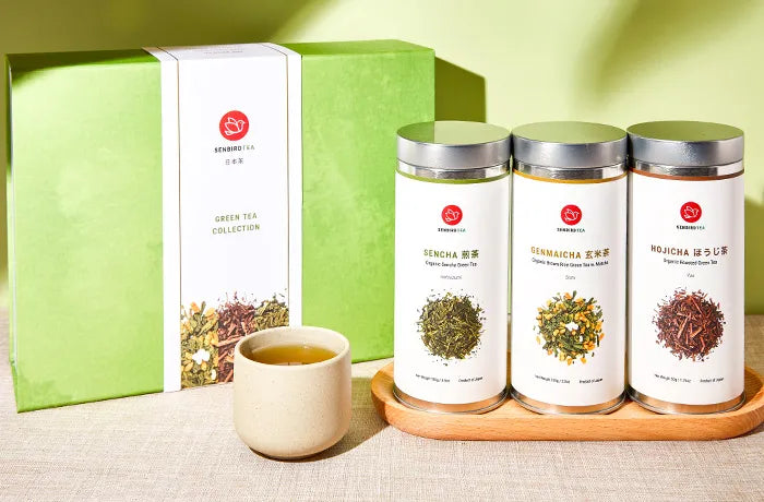 green tea gift set sencha genmaicha hojicha tea tins with brewed green tea in a teacup and green tea gift box