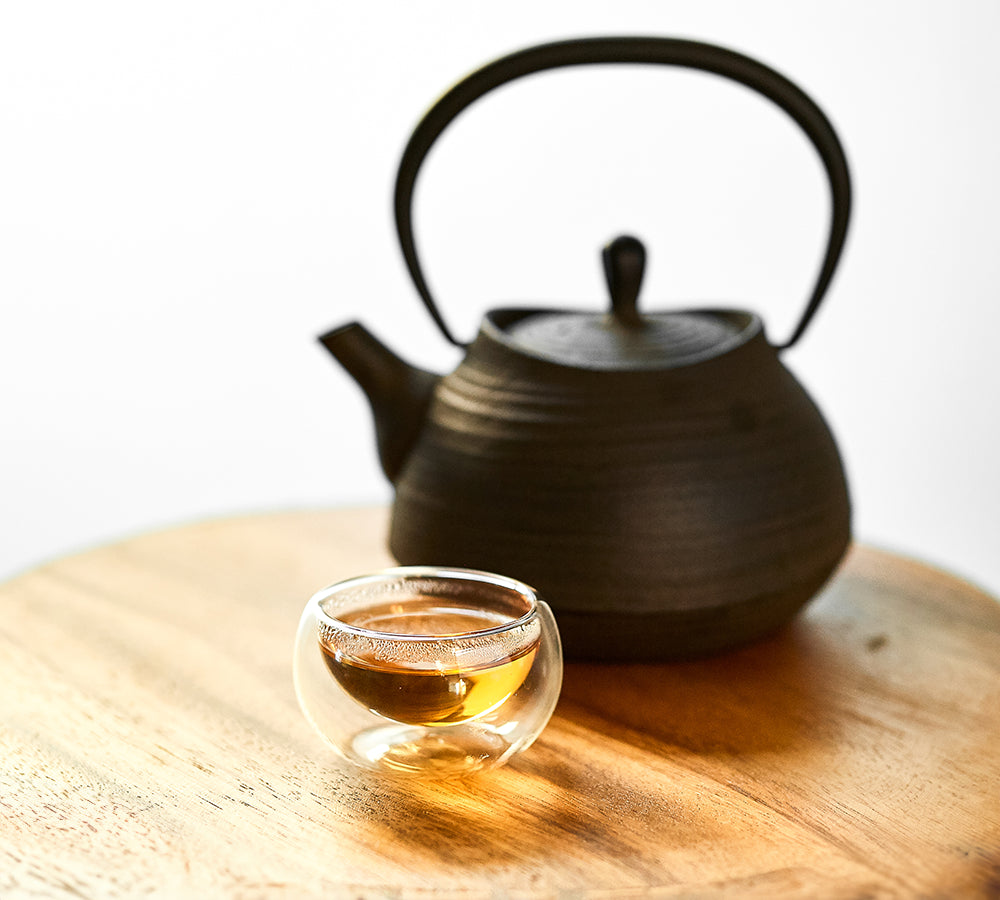 Sobacha, Kuromamecha, Mugicha Japanese herbal tea with black teapot and amber glass cup