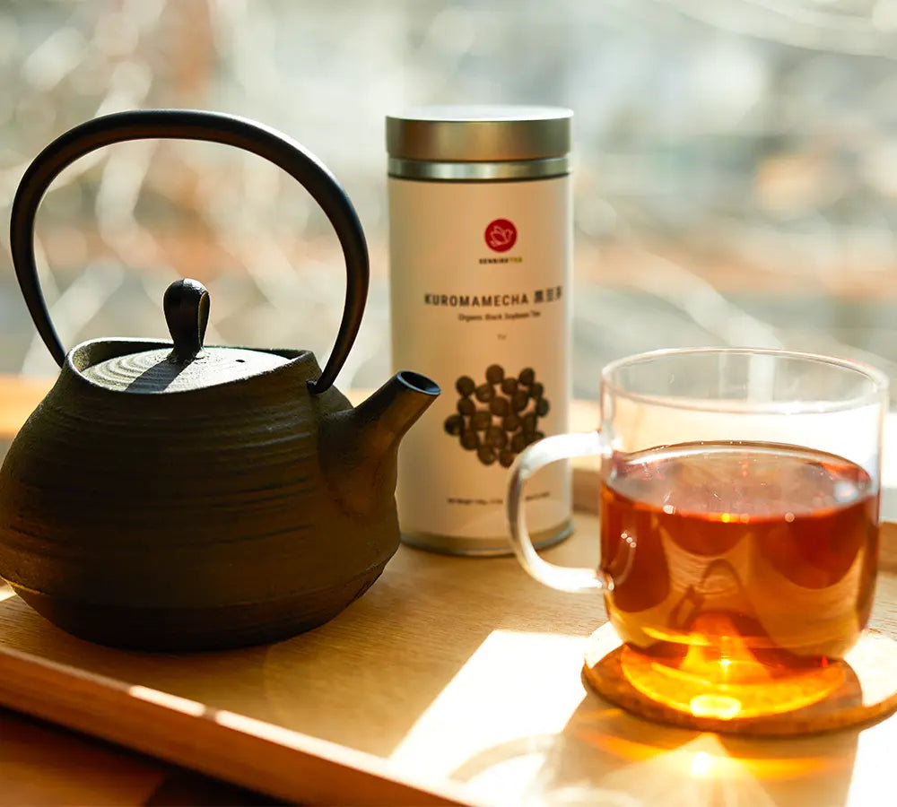 Kuromamecha Japanese herbal tea with tin, glass mug, and tetsubin