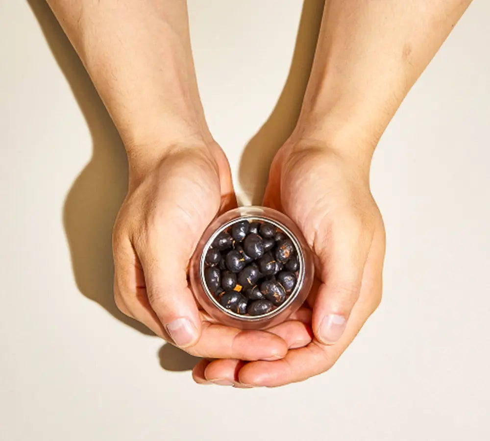 Kuromamecha Japanese herbal tea roasted black soybeans held in glass canister