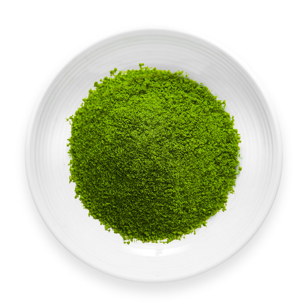Aojiru green powder blend with young barley grass, kale, and ashitaba on a white dish