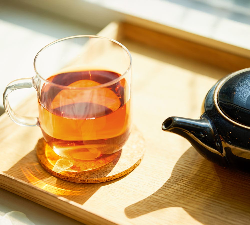 Wakoucha Japanese tea mug with black teapot in sunlight