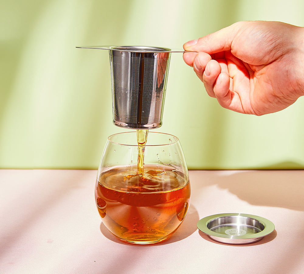 Wakoucha Japanese tea poured from metal infuser into glass cup